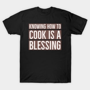 Knowing how to cook is a blessing. T-Shirt